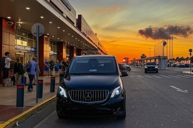 Driver loading a luxury minivan with suitcases
